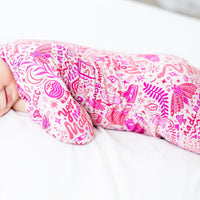 Baby sleeping in a pink Mystic Mama second-skin romper with Raising Mama viscose from bamboo.
