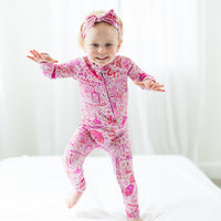 Toddler wearing pink printed zippered romper from The Second-Skin Convertible Romper by Pink Mystic Mama.