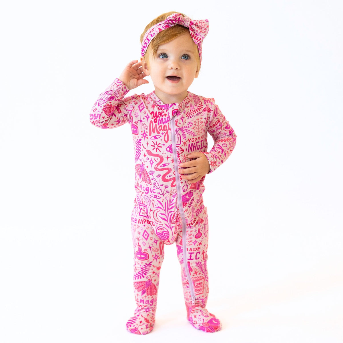 Stylish view of The Second-Skin Bamboo Zippered Footie | Mystic Mama, highlighting its cozy fit and vibrant pink color.