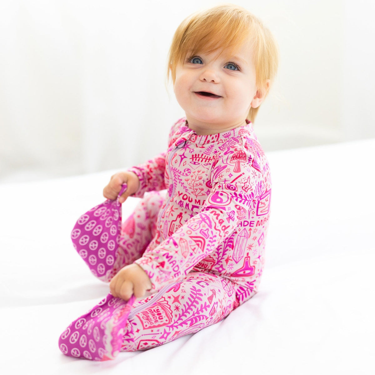 The Second-Skin Bamboo Zippered Footie | Mystic Mama stretches beautifully in a gentle setting, showcasing its flexibility and design.