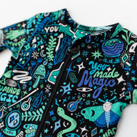 The Second-Skin Footie in Blue by Mystic Mama, zippered one-piece with bold teal print