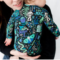 Pregnant wearer in The Second-Skin Footie, Mystic Mama blue, with celestial print while cradling her belly.