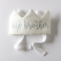 White crown with 'big brother' embroidery on a light gray background