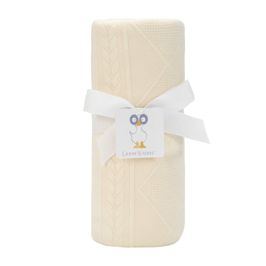 Oatmeal Knit Blanket by Goosewaddle®, elegantly wrapped with a ribbon, showcasing its soft texture and neutral color, perfect for newborns.