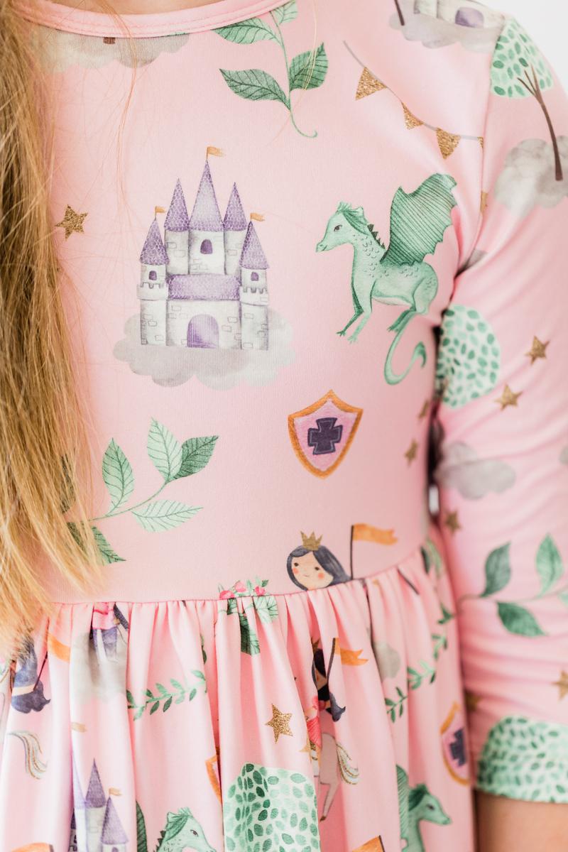 Close-up of the Once Upon a Time 3/4 Sleeve Pocket Twirl Dress by Mila & Rose, showcasing enchanting details like a castle, dragon, and leafy patterns perfect for sparking imagination.