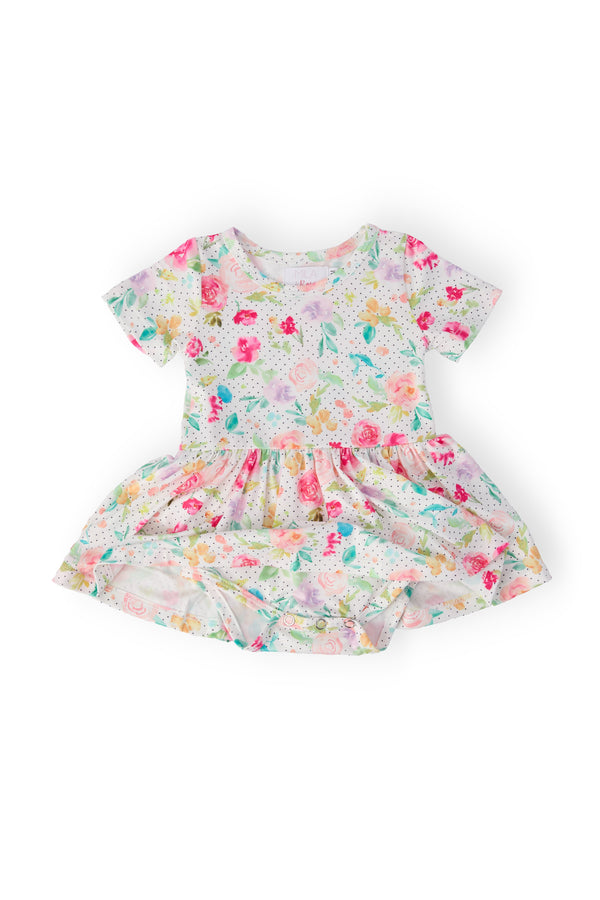 Cute baby wearing the Painted Posies Short Sleeve Summer Baby Romper with Twirl Skirt, showcasing the playful twirl design and soft fabric ideal for summer adventures.