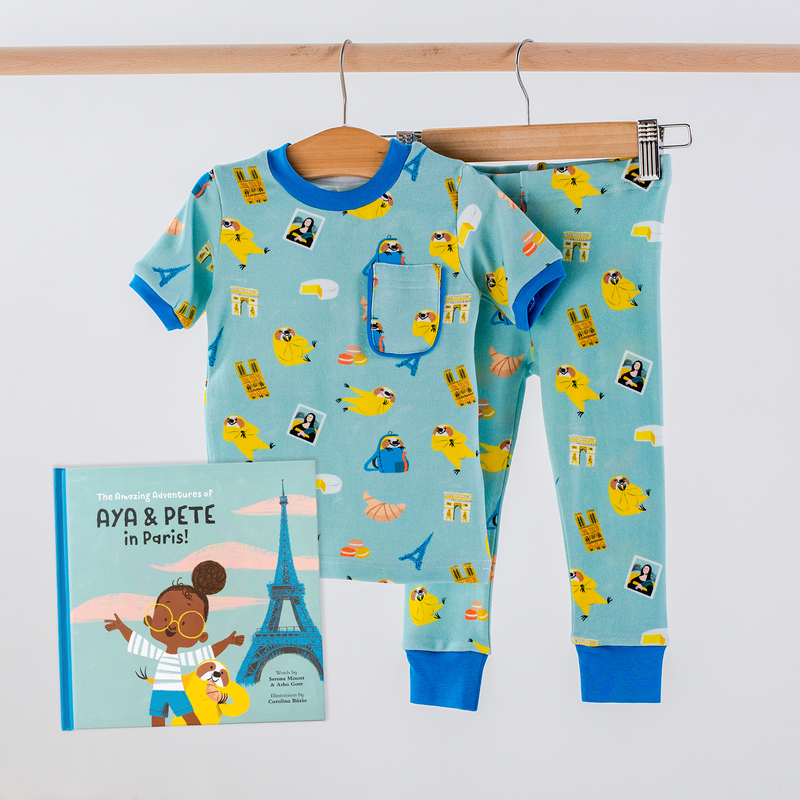 Aya & Pete in Paris Organic Cotton Kids Pajamas & Book Set: turquoise PJs with Paris landmarks and birds.