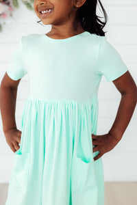 Pastel green short-sleeve pocket twirl dress for girls, comfy, easy to wash, with pockets.