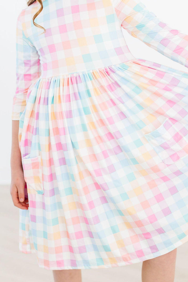 Detailed view of the skirt and pockets of the Pastel Plaid 3/4 Sleeve Pocket Twirl Dress from Mila & Rose, emphasizing its functional design and lively colors.