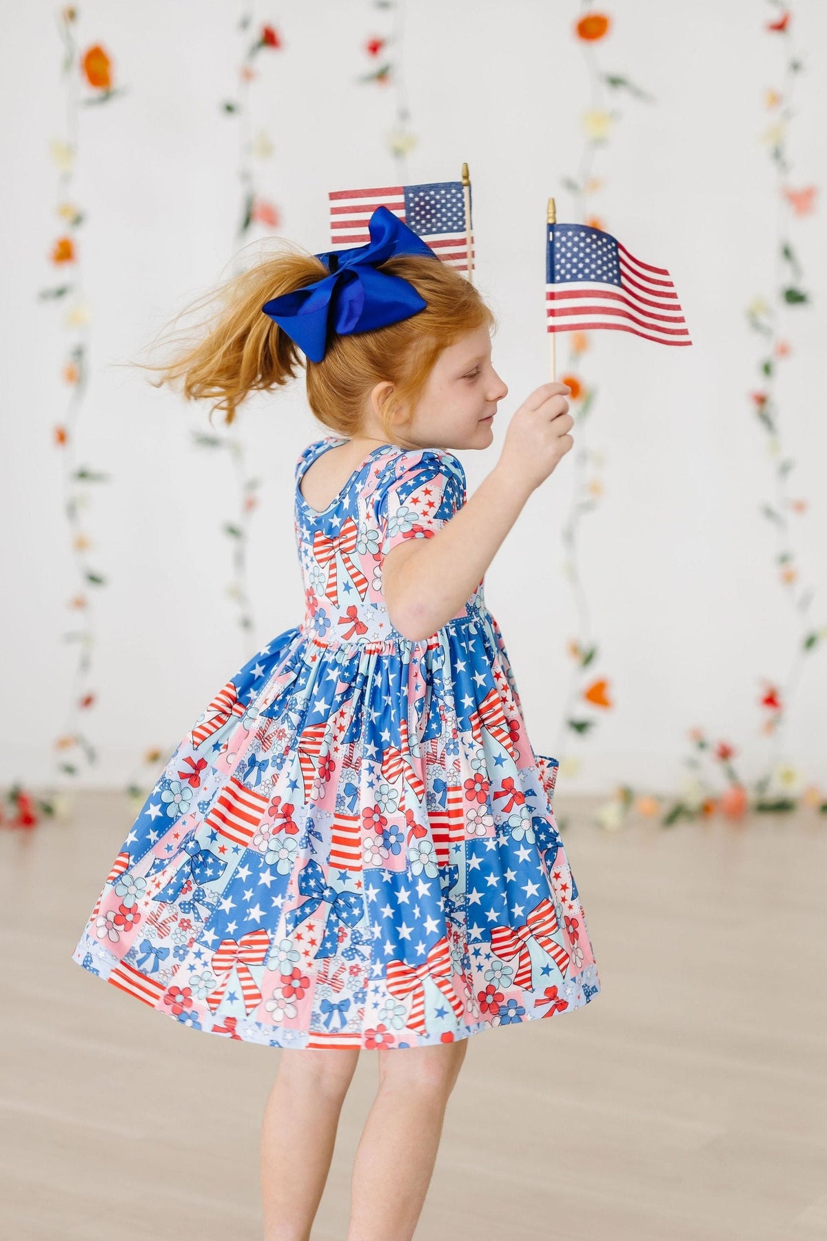 Toddler girls blue and red pocket twirl dress with American flag print and short sleeves