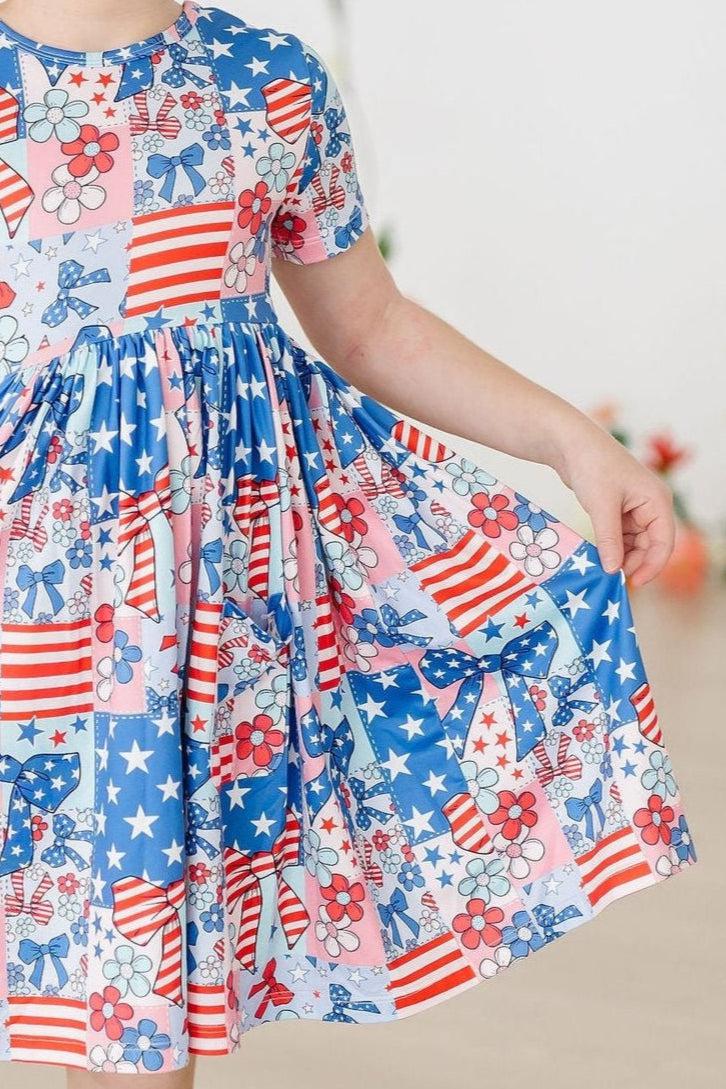 Girls patriotic pocket twirl dress in red white and blue with short sleeves and star and flag pattern