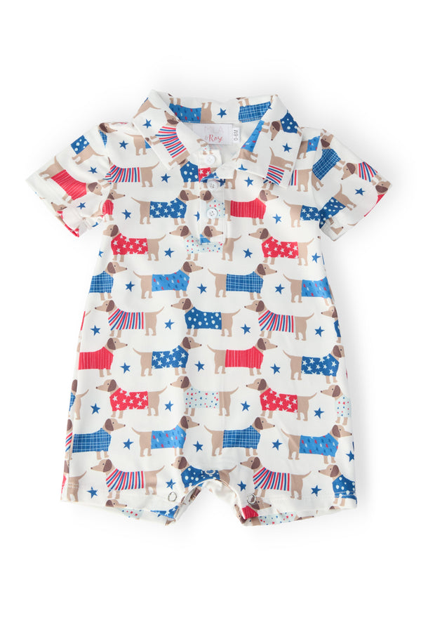 Patriotic Pups Polo Shorty One-Piece: soft summer baby outfit with red, white, blue dog prints and stars; snap closure.