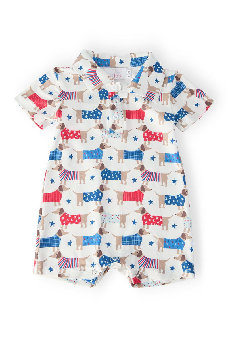 Patriotic Pups Polo Shorty One-Piece: soft summer baby outfit with red, white, blue dog prints and stars; snap closure.