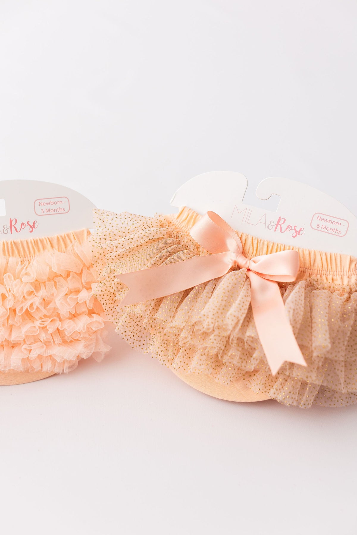 Peach & Gold Glitter Tutu Bloomers by Mila & Rose, showcasing playful ruffles and a sweet bow, ideal for special occasions.