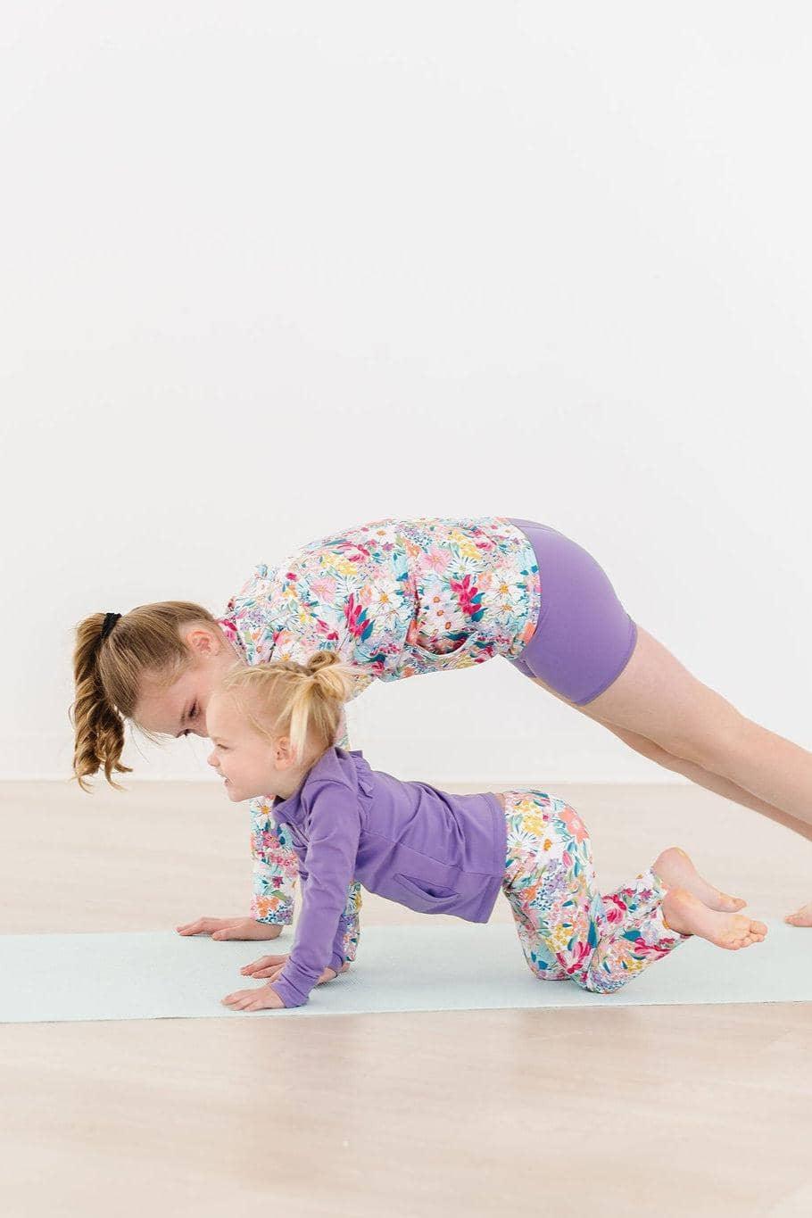 Girls floral active jacket with purple shorts and toddler purple active jacket with floral pants playing on yoga mat