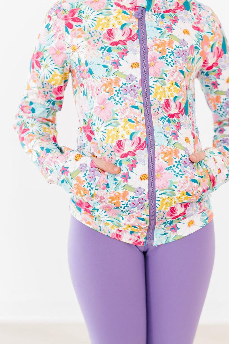 Close-up of the Petal Power Full-Zip Ruffle Active Jacket, highlighting its colorful floral design and fitted look, perfect for trendy little ones.