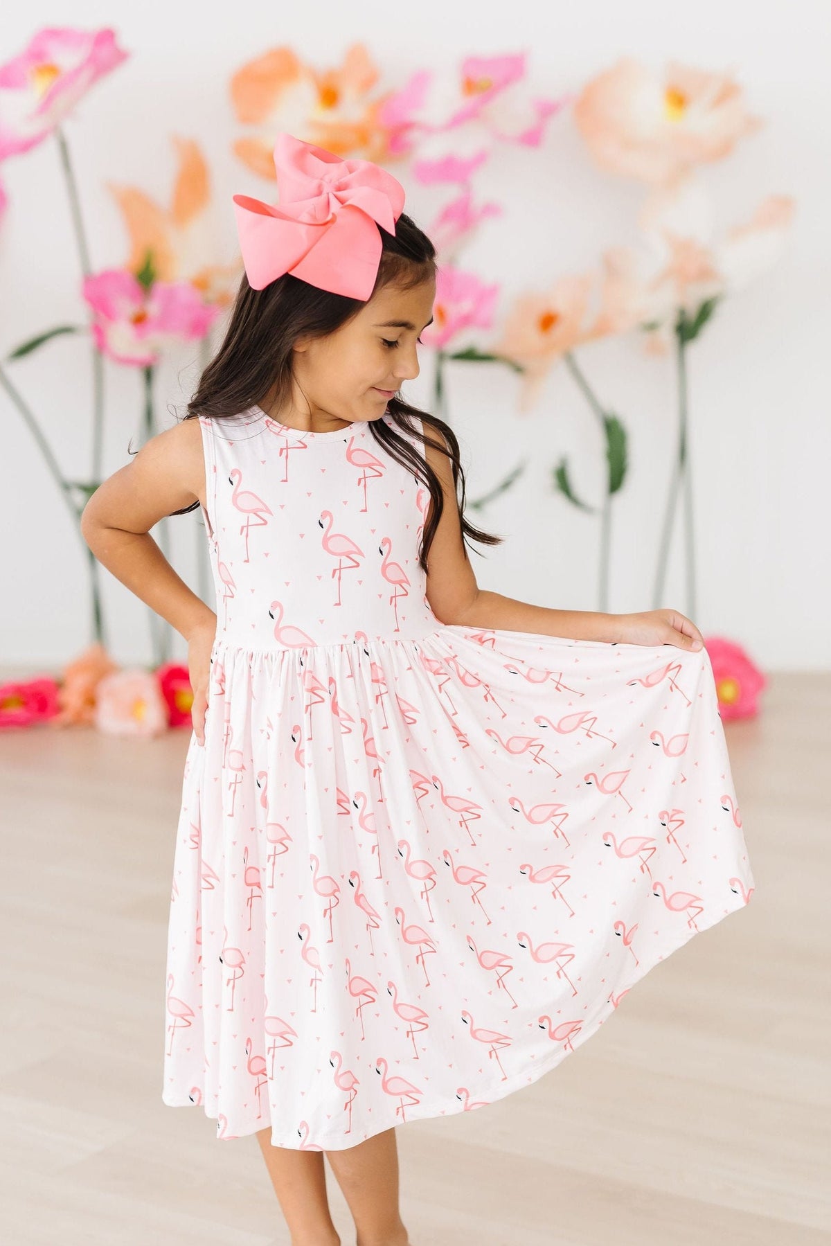 Happy girl wearing a Pink Paradise Flamingo Tank Girls Twirl Dress, showcasing comfort and style during outdoor adventures.