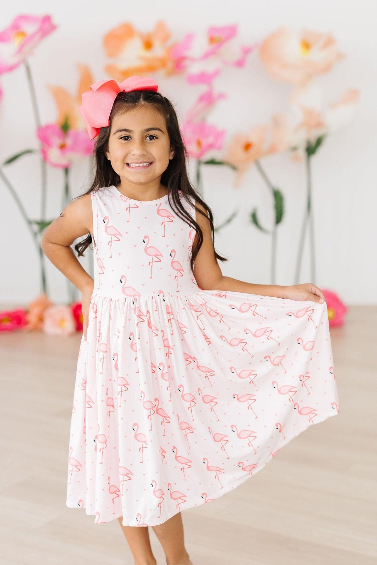 Close-up of the Pink Paradise Flamingo Tank Girls Twirl Dress, highlighting the soft fabric and lovely sleeveless design for active girls.
