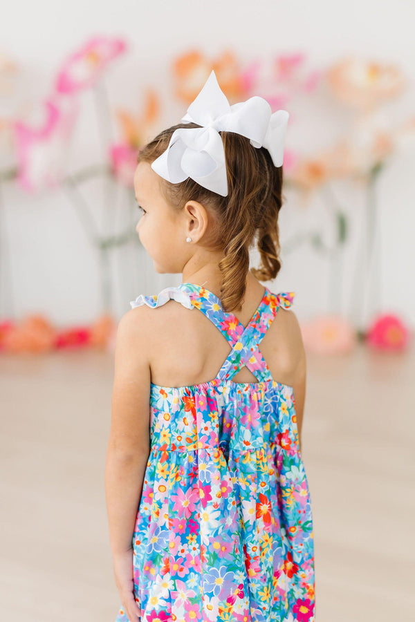 Preppy Floral Ruffle Cross Back Dress on a girl with a white bow headband.