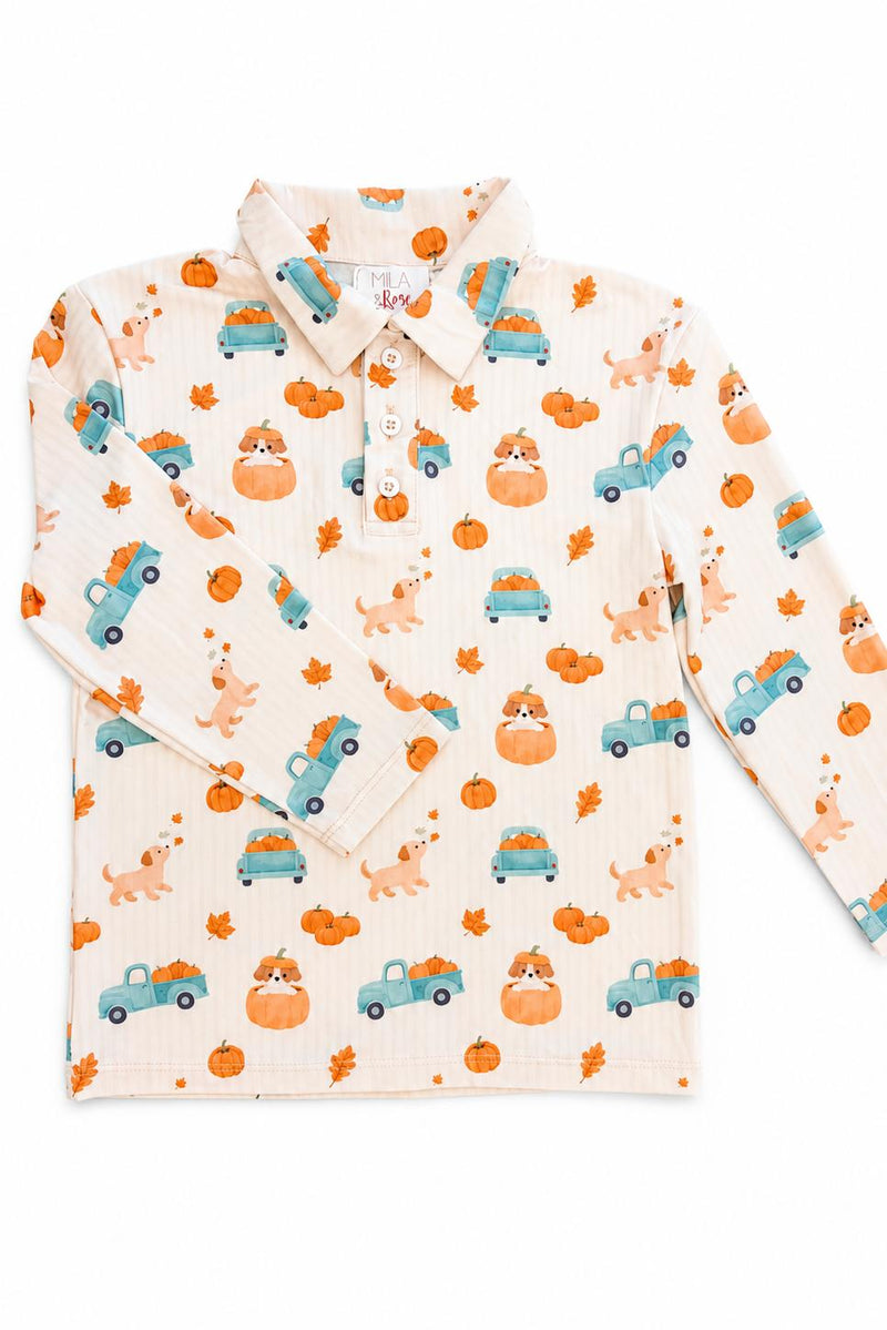 Pumpkin Spice Pups long sleeve polo on cream background with pumpkins, blue trucks, and playful pups.