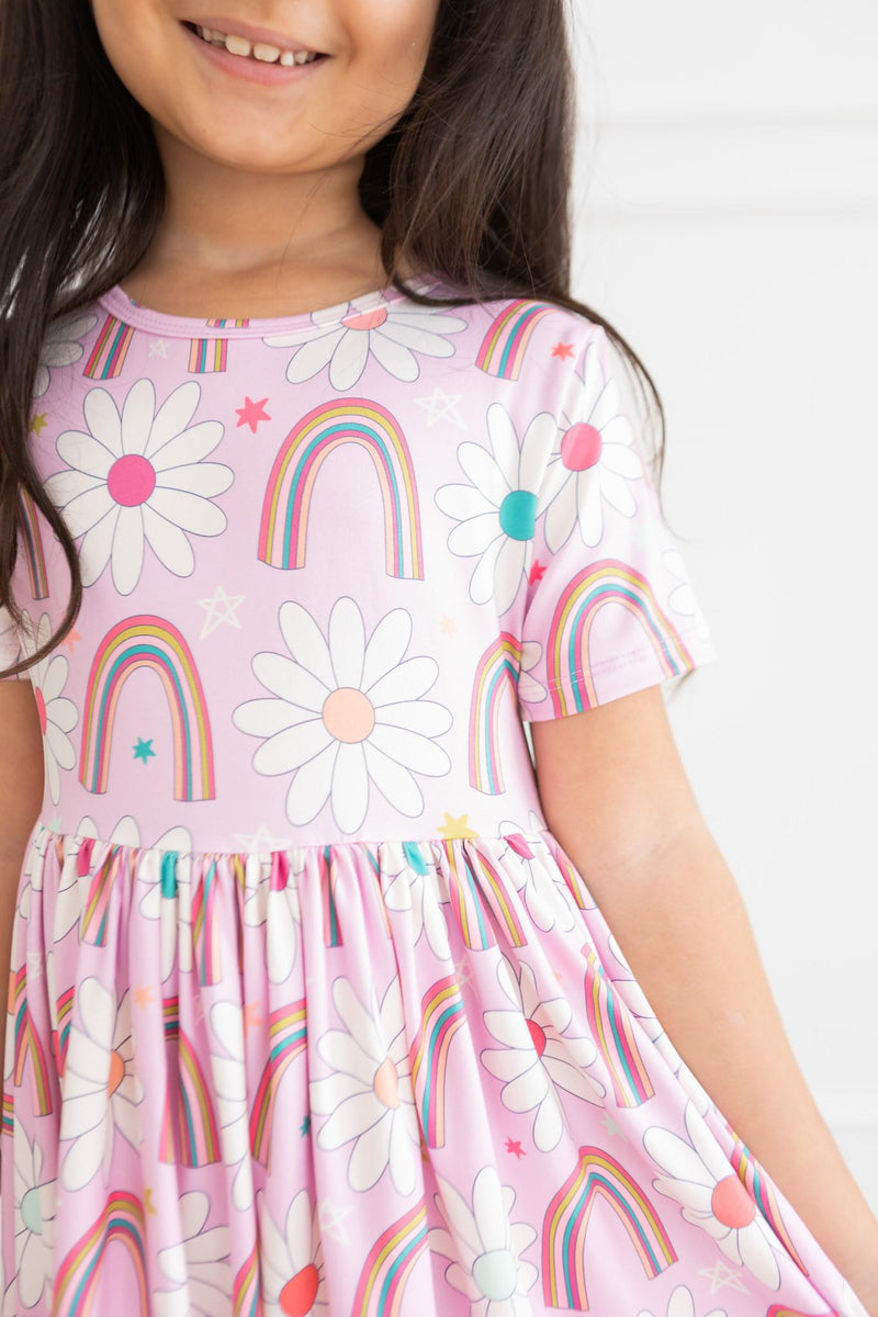 Beautifully flared skirt of the Whimsical Rainbow Daisies Short Sleeve Pocket Twirl Dress for Girls, ideal for twirling and play, a perfect twirl dress for girls.