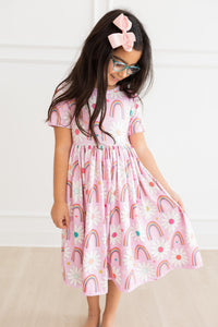 Whimsical Rainbow Daisies Short Sleeve Pocket Twirl Dress for Girls showcasing vibrant colors and playful design, perfect as a twirl dress for girls.