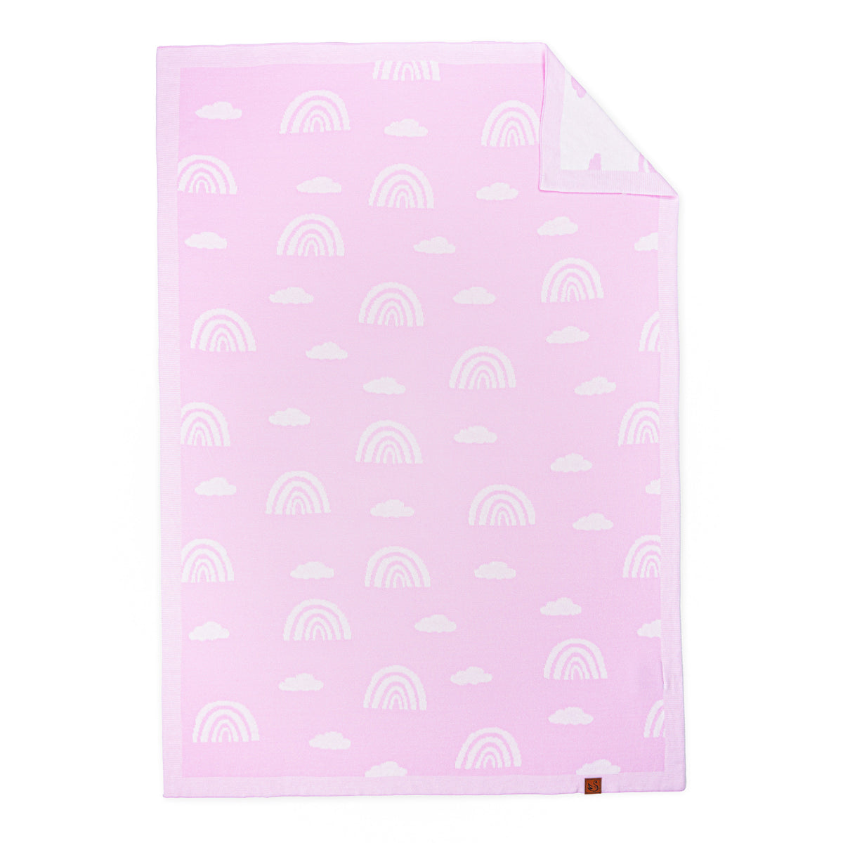 Lilac pink baby blanket with white rainbow jacquard pattern, folded corner showing white reverse and brown brand tag