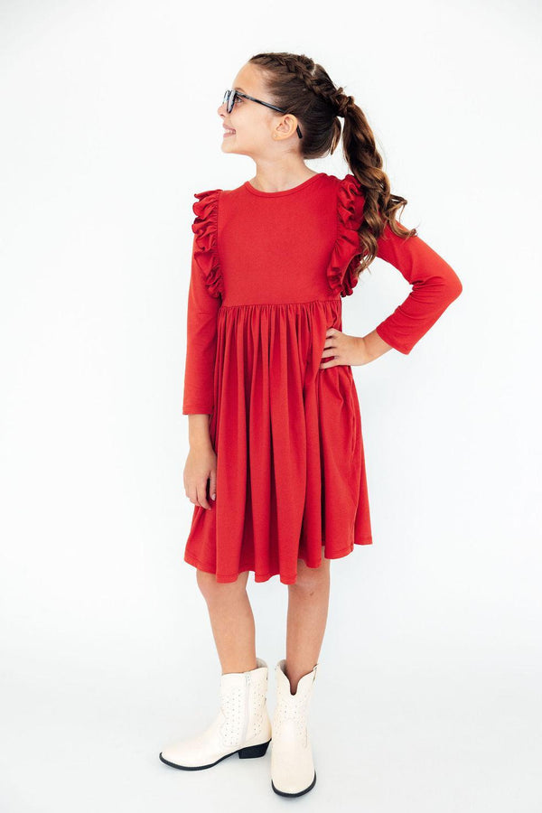 Girl in red long sleeve ruffle twirl dress with white cowboy boots. Comfortable, easy-wash toddler dress designed for play and special occasions.