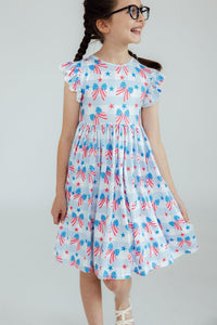 Red, White & Bows Flutter Sleeve Twirl Dress on a smiling girl with braided hair.