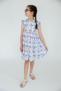 Red, White & Bows Flutter Sleeve Twirl Dress with scoop back on a girl; patriotic bow-print and flutter sleeves.