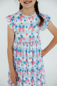 Red, White & Bows Flutter Sleeve Twirl Dress with bow-and-star print on a girl.