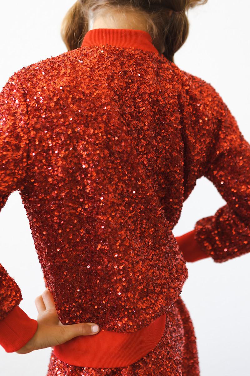 Cheerful child in a Red Sequin Jacket posing confidently for a photo, ready to dazzle at any event.