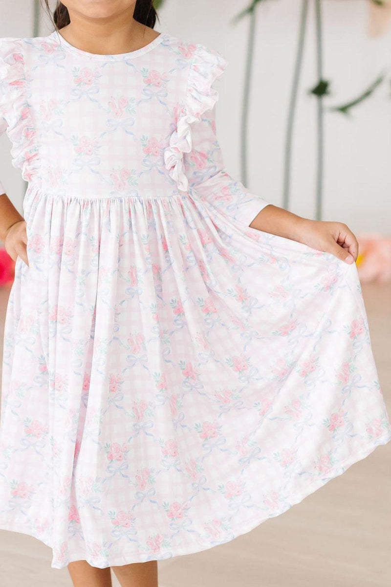 Ribbons & Roses 3/4 Sleeve Ruffle Twirl Dress on a young girl, showcasing a beautiful floral pattern and ruffle details, perfect for playful occasions.