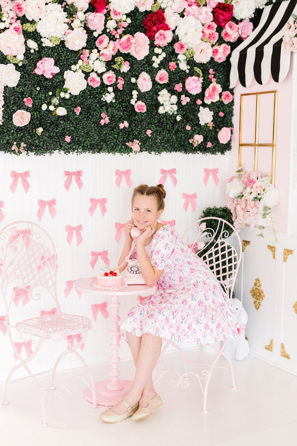 Rose Garden Smocked Ruffle Dress on Mila with a stretchy smocked bodice and ruffle skirt.