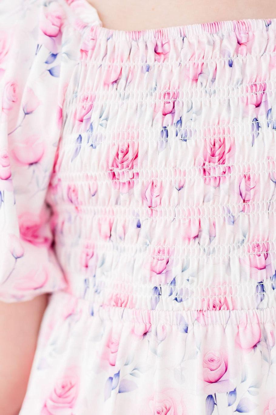 Rose Garden Smocked Ruffle Dress: pink floral print, stretchy smocked bodice, and ruffle skirt.
