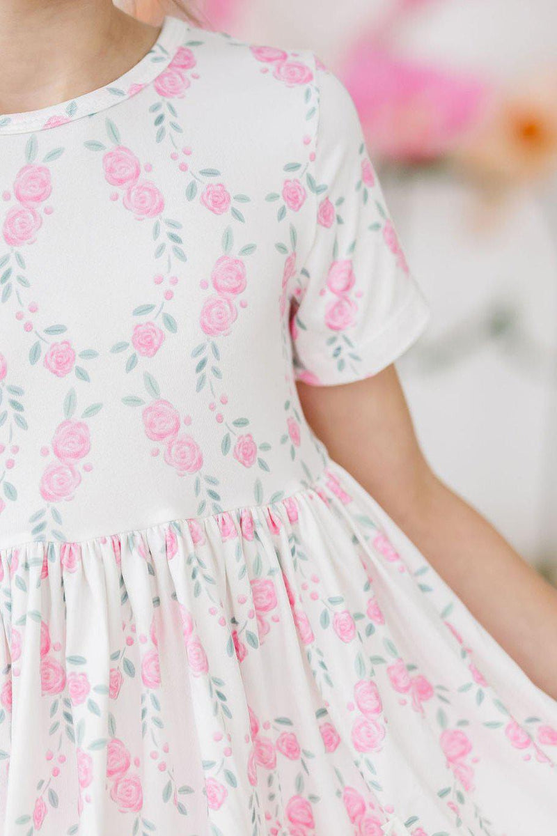 Cute little girl wearing the Rosie Posie S/S Pocket Twirl Dress by Mila & Rose, showcasing the twirl-worthy design perfect for playdates and special occasions.
