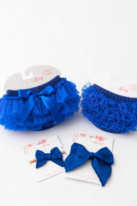 Pair of royal blue ruffle bum bloomers with back-only ruffles and bows, for newborn photos or cake smash.