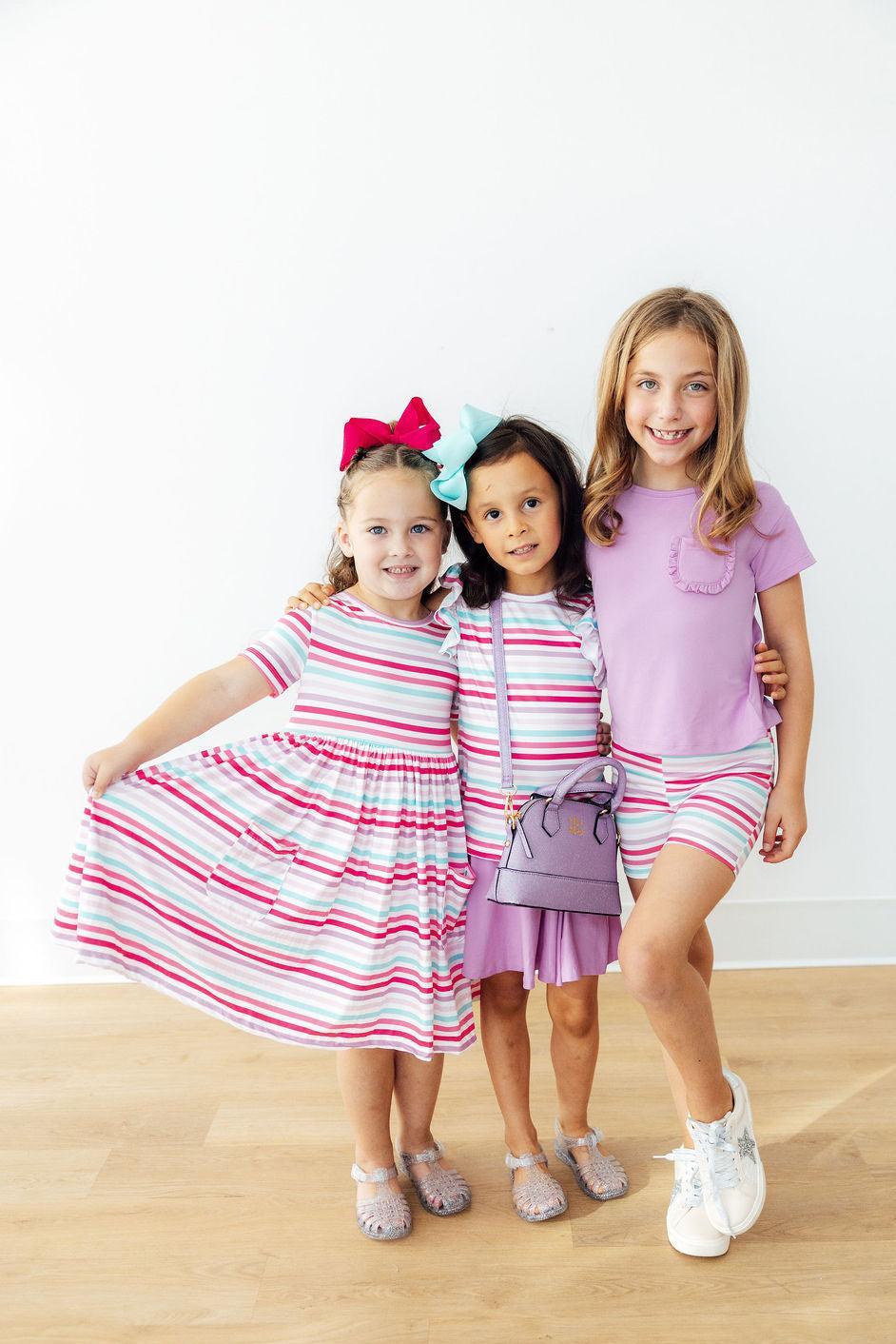 Close-up of the Pastel Stripes Short Sleeve Twirl Dress for Girls featuring pockets, ideal girls twirl dress for everyday wear.