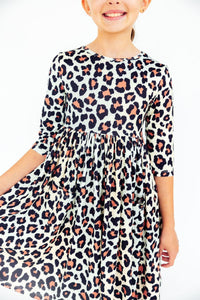 Girls leopard print 3/4 sleeve pocket twirl dress. Scoop back design perfect for school, special occasions, and everyday play.