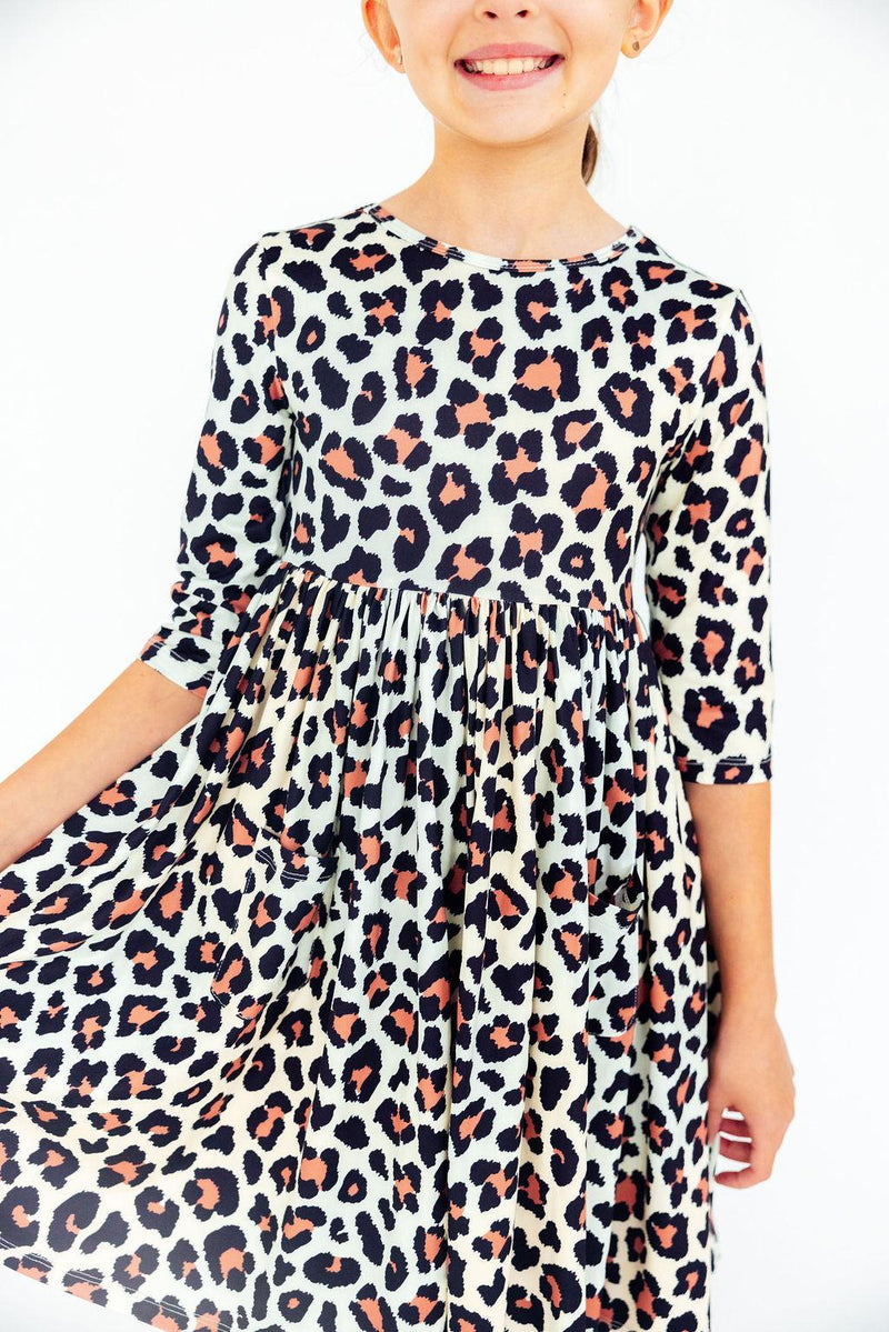 Girls leopard print 3/4 sleeve pocket twirl dress. Scoop back design perfect for school, special occasions, and everyday play.