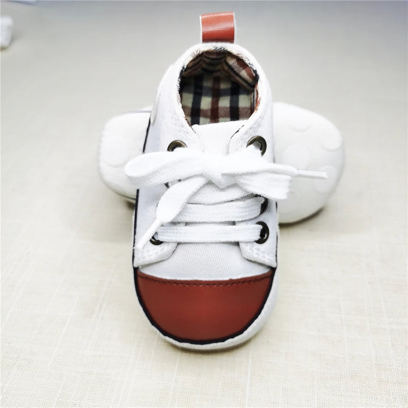 Adorable Baby's Canvas Lace-up Soft Sole First Walkers - Sophisticated Brown Tip displayed to showcase the soft cork sole for comfort and support during first steps.