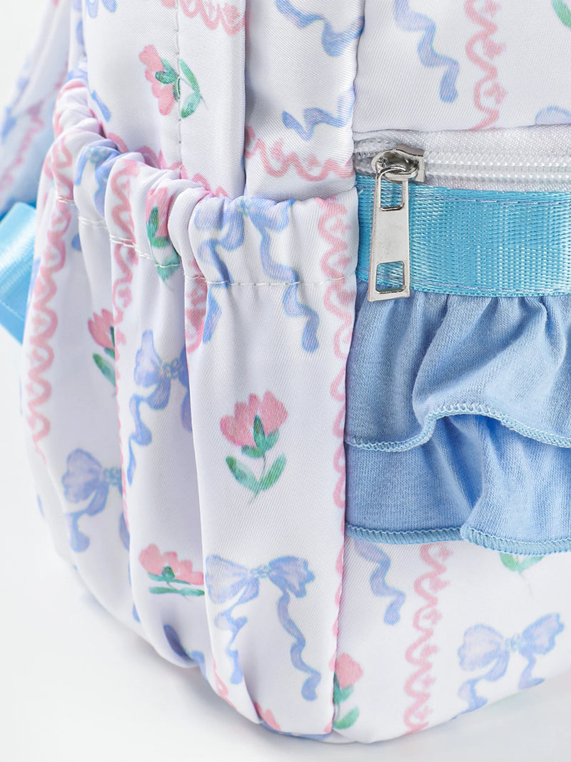 Back view of the Flowers & Bows Floral Printed Backpack, highlighting the durable polyester material and zipper closures for secure storage.