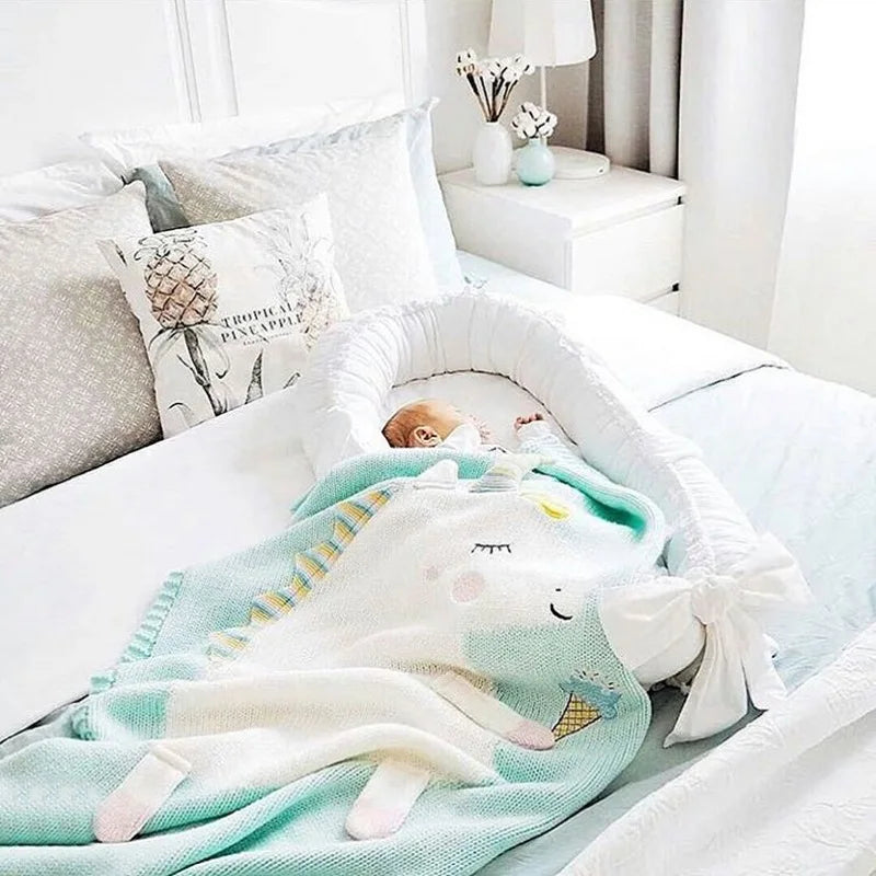 A baby sleeping soundly under a unicorn blanket, featuring designs from the 'Sleepy Tight' cute animal blankets.