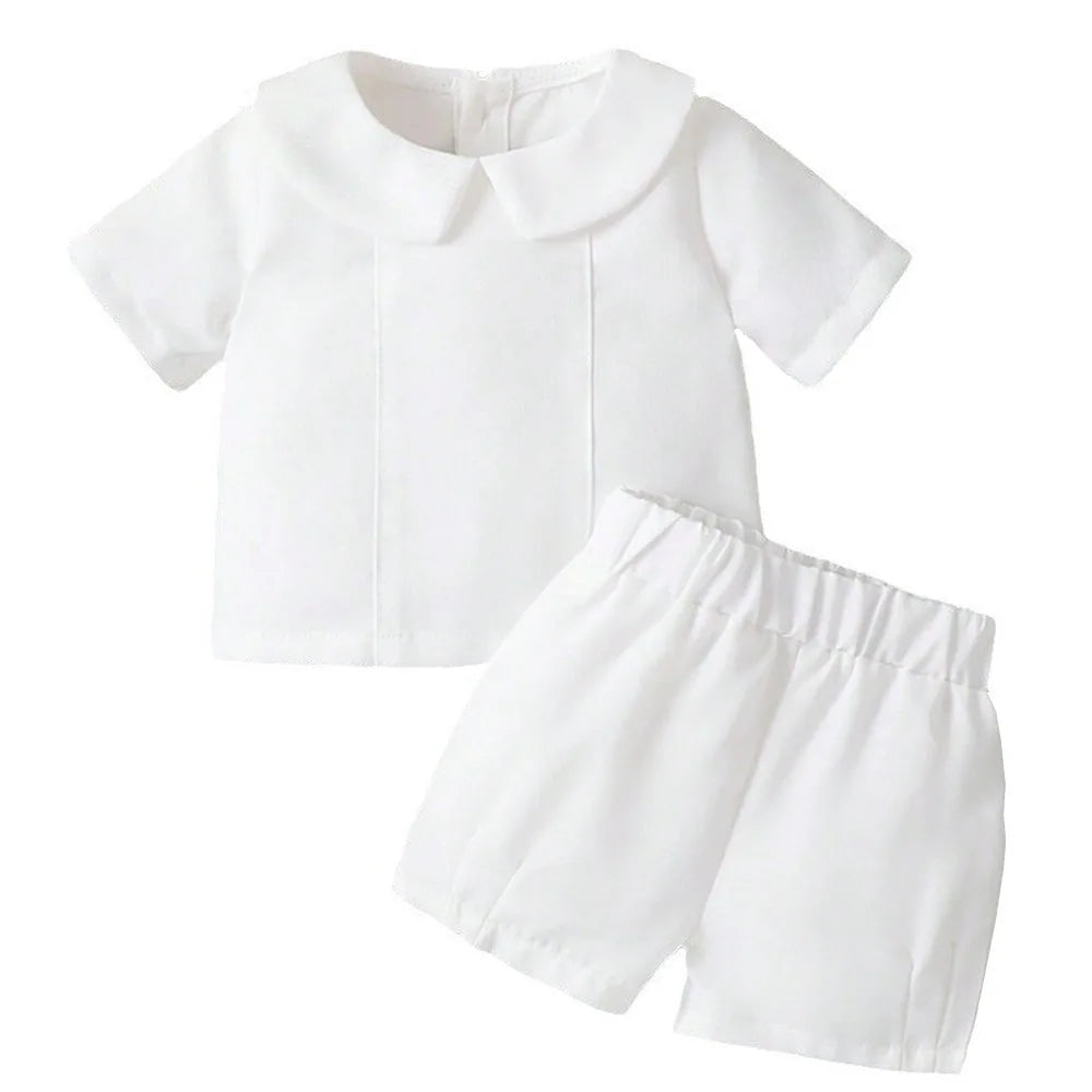 White 2-piece boys baptism outfit with turn-down Peter Pan collar short-sleeve top and elastic waist shorts, combed cotton.