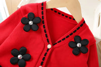 Red Vanessa floral knitted cardigan for girls with black flower appliques and rhinestone centers.