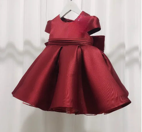 Patience Marie red satin knee-length princess dress for girls with cap sleeves and wide waist sash.