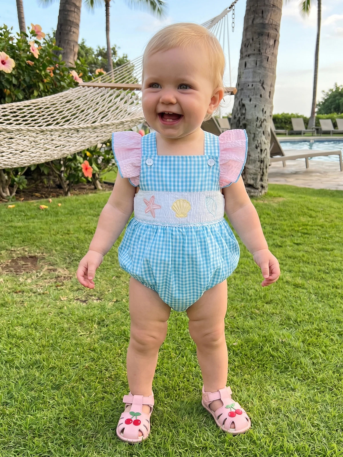 Take Me Out To The Seashore romper: Baby to Toddler, blue gingham, pink flutter sleeves, embroidered sea creatures.
