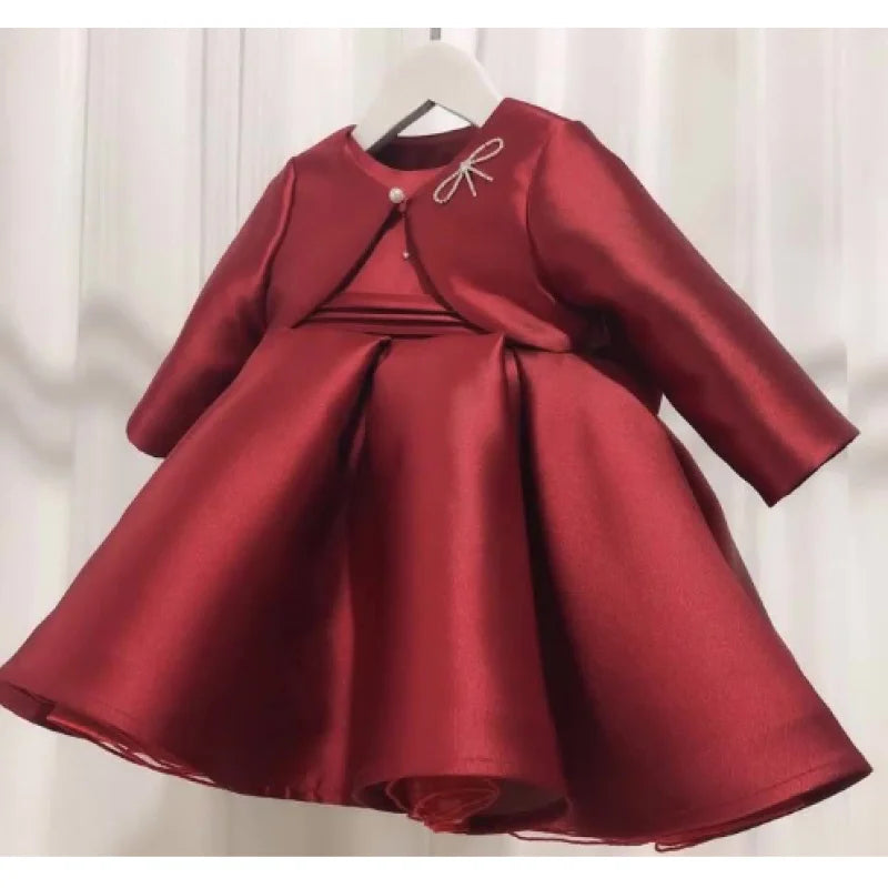 Patience Marie red satin girls' knee-length dress with long sleeves, beaded bow, princess silhouette.