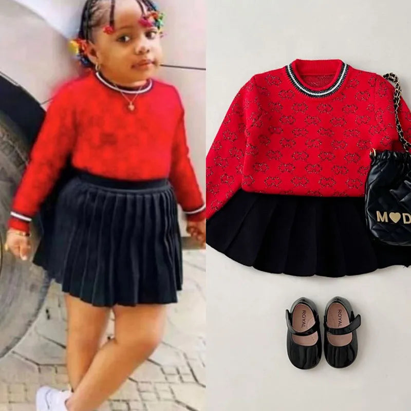 Little girl wearing the 'Morgan' Classic Knit Skirt Set, showcasing the vibrant red sweater with black skirt, perfect for fall and winter.
