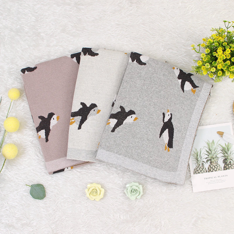 Collection of Little Penguins Children's Knit Blankets in various colors, showcasing the vibrant options for playful and stylish decor.